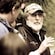 A man talks to a group of people in a forest